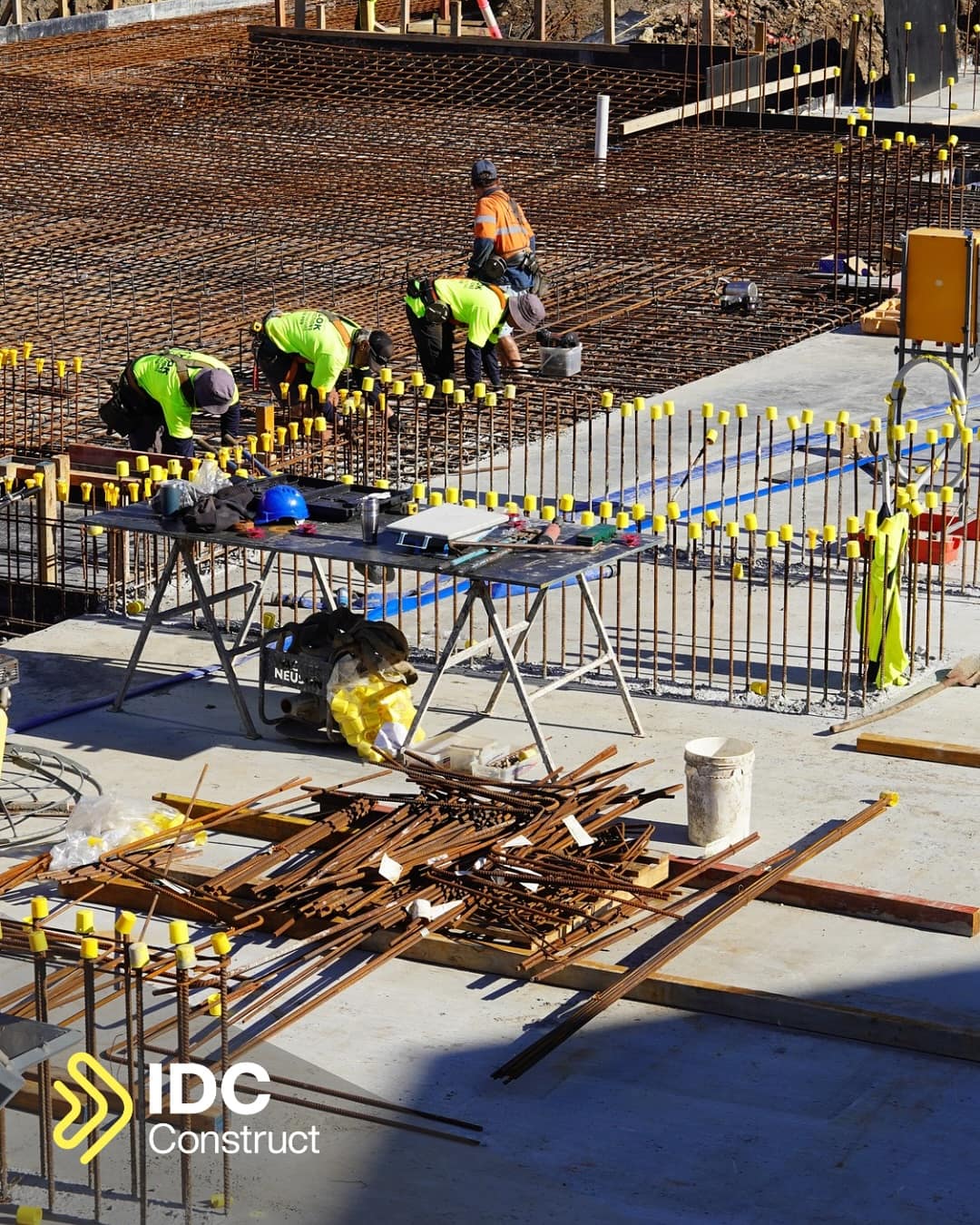 IDC Construct crew tying steel reinforcement across the slab ahead of a pour